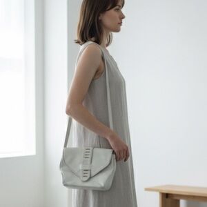 Vintage 1980s white leather shoulder bag with mixed metal hardware